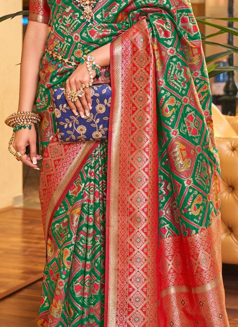 Classy Dark Green Patola Silk Saree with Extraordinary Blouse Piece