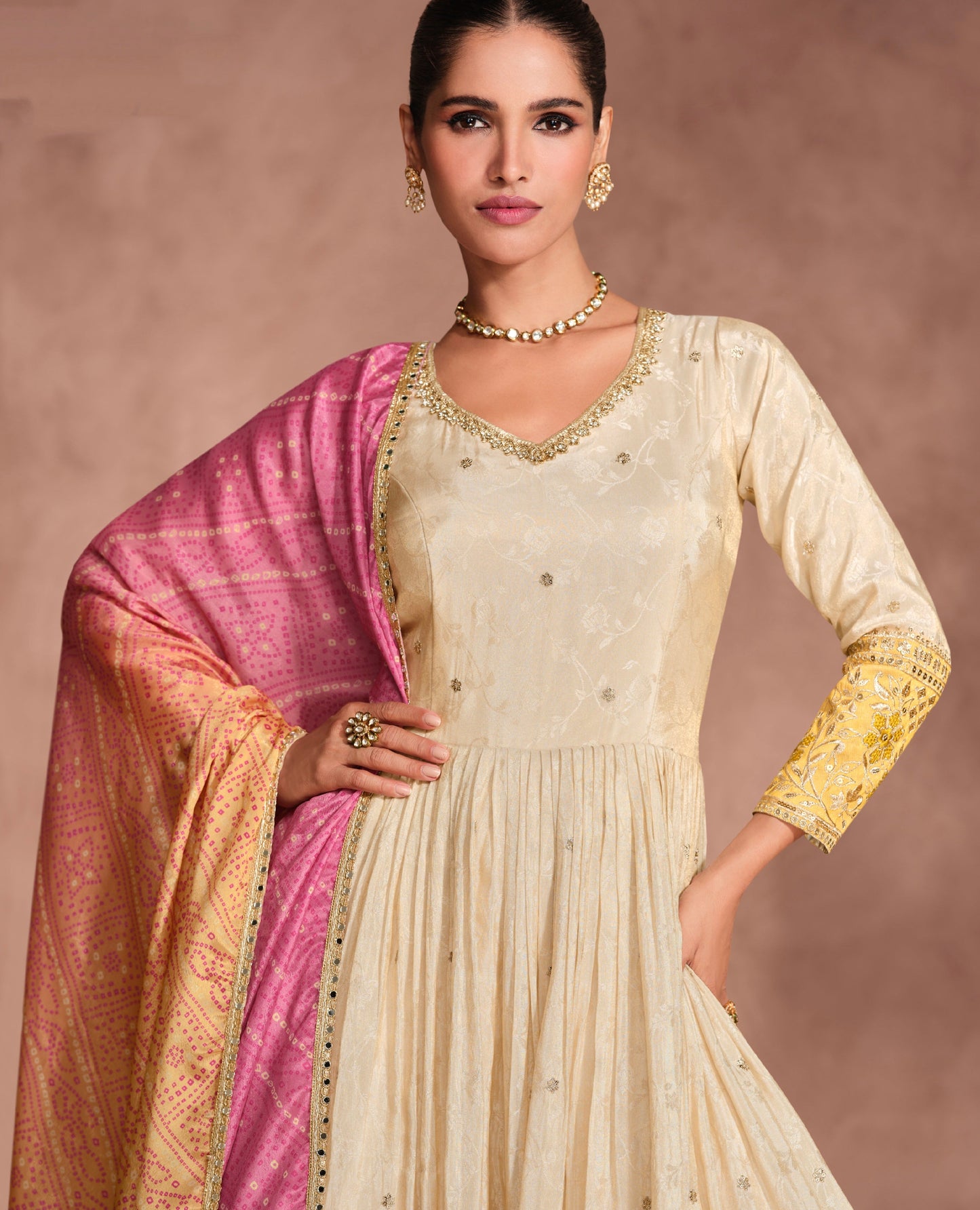 Cream Anarkali Suit with Golden Embroidery and Pink Bandhani Dupatta