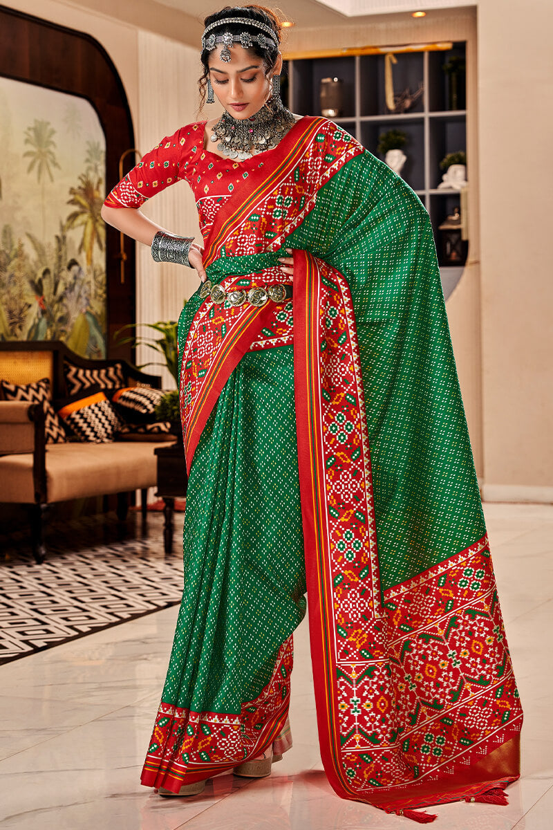 Denouement Dark Green Patola Silk Saree with Moiety Blouse Piece