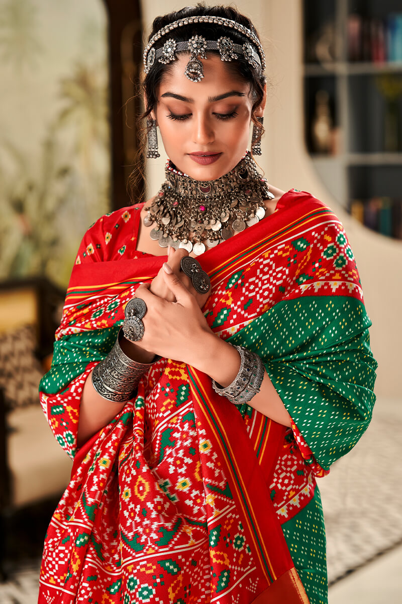 Denouement Dark Green Patola Silk Saree with Moiety Blouse Piece