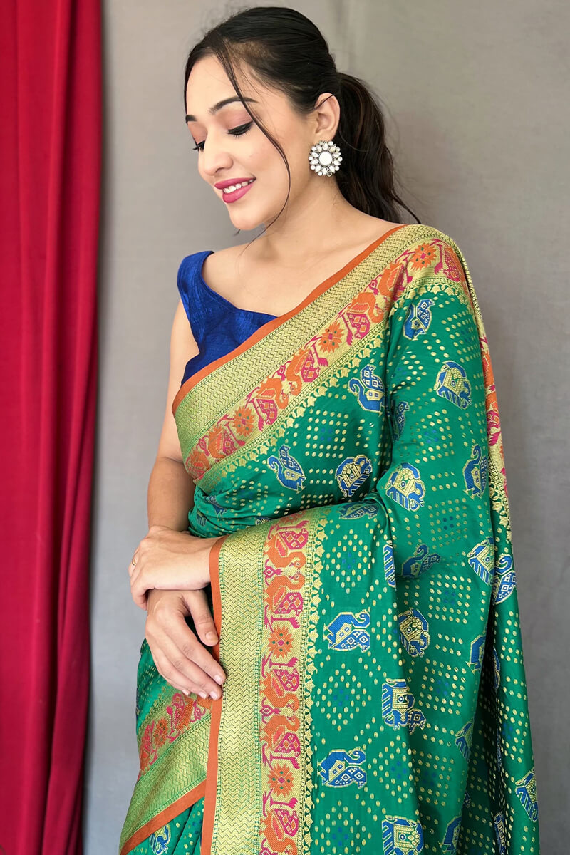 Mesmeric Green Patola Silk Saree with Twirling Blouse Piece